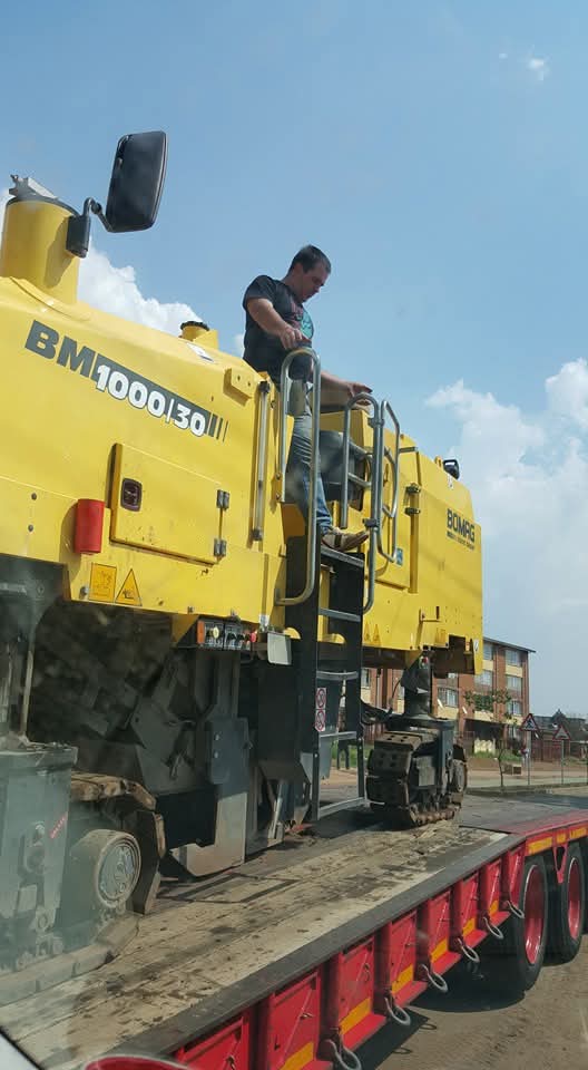 Nicolaas working with heavy milling equipment. skills shared between farm and road sites.